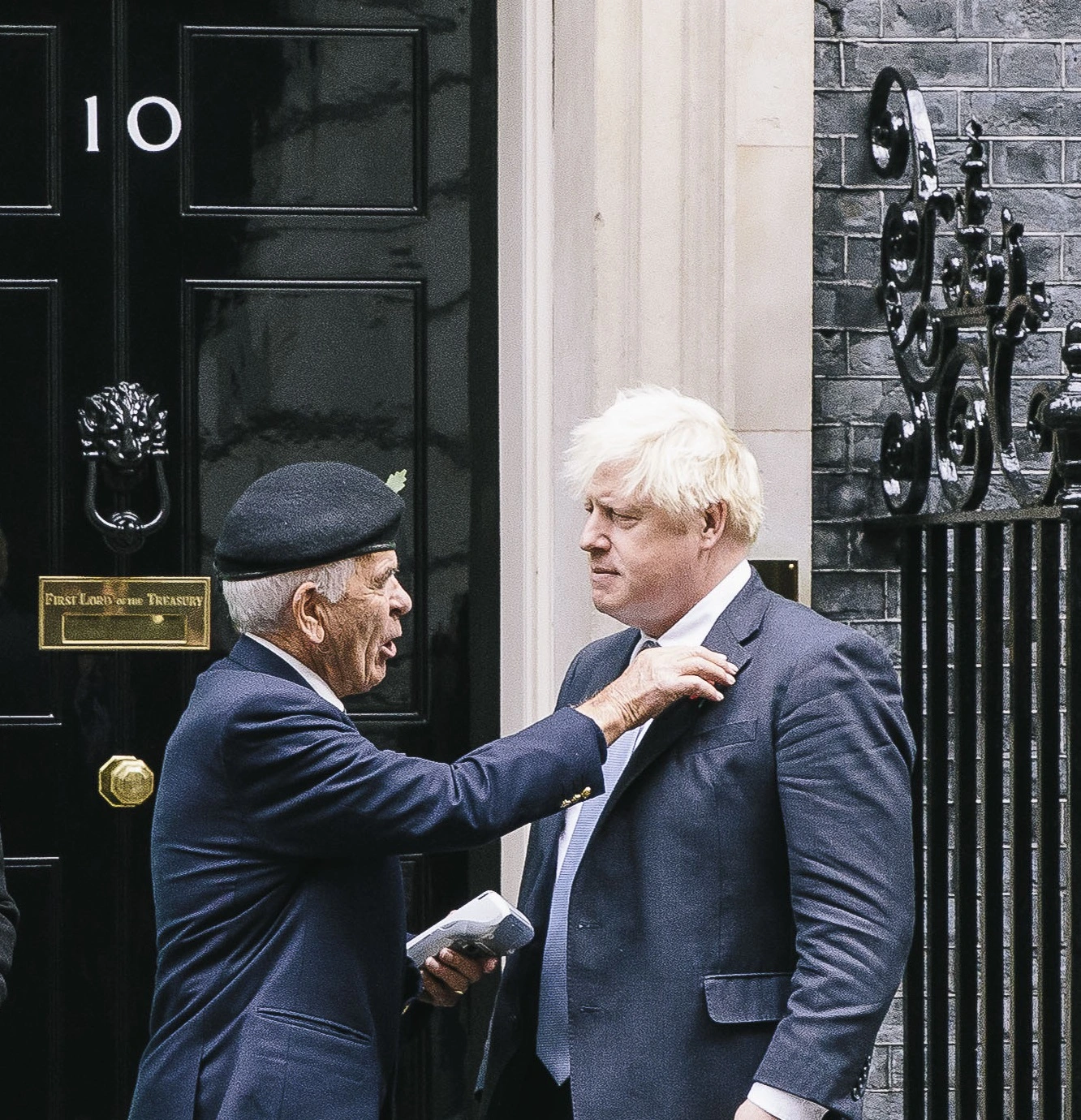 Collector pinning a poppy on Prime Minister Boris Johnson
