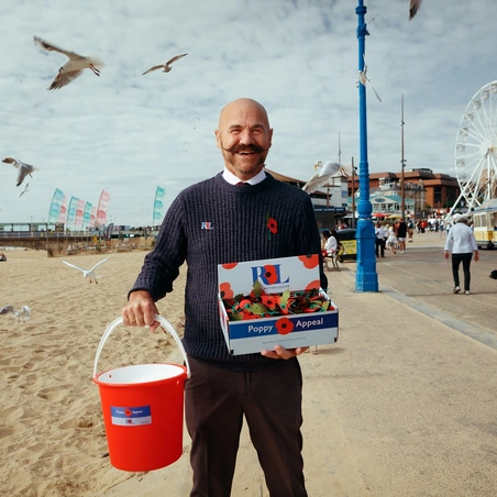 Dave Kelsey holding Poppy Appeal collection bucket Dave Kelsey holding Poppy Appeal collection bucket