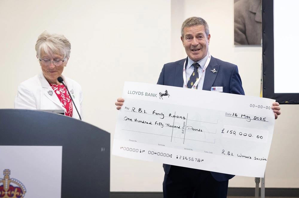 , presents Antony Baines, Executive Director, Services with a cheque to support refurbishment of family rooms in RBL's care homes.