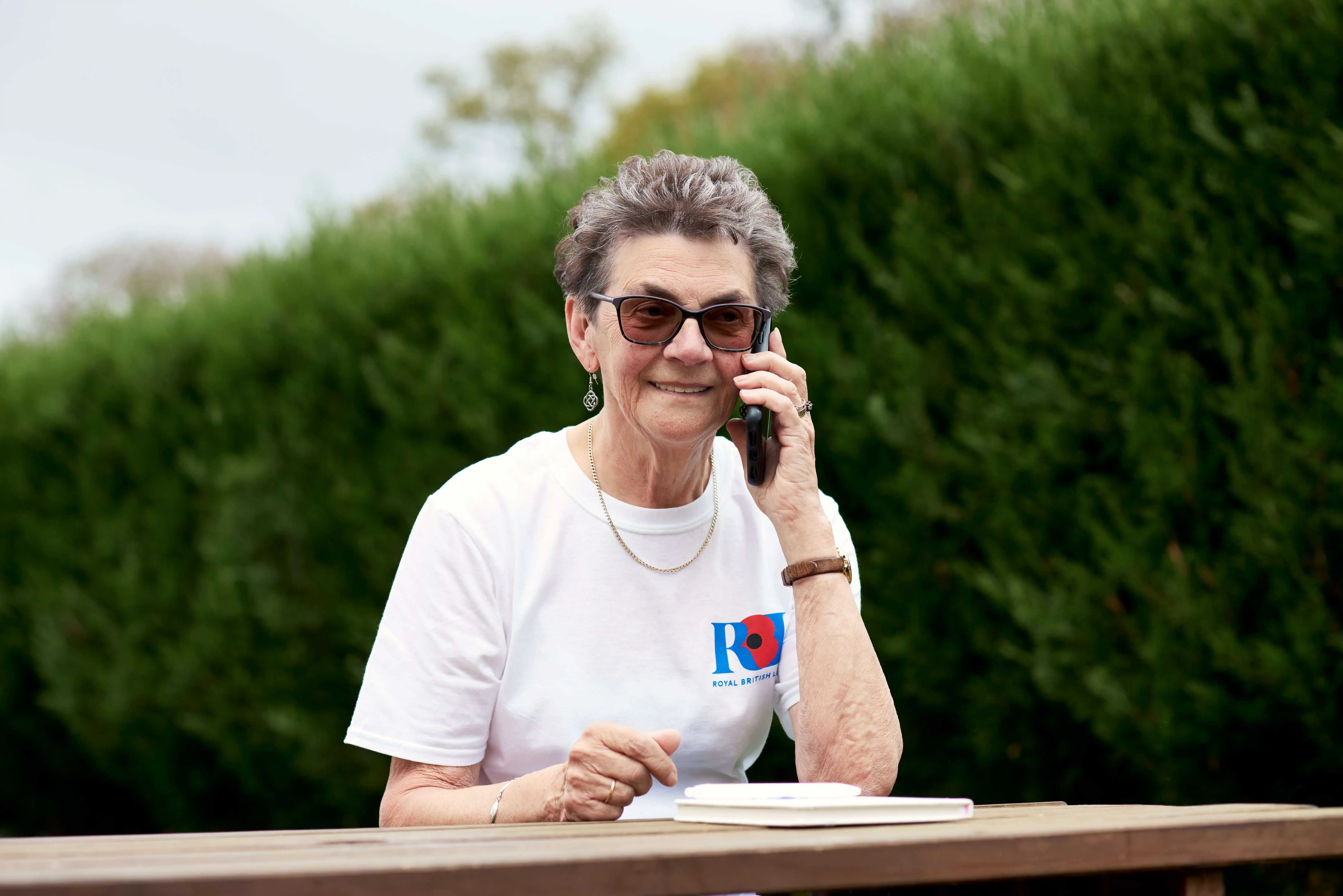 Lady on phone wearing RBL top