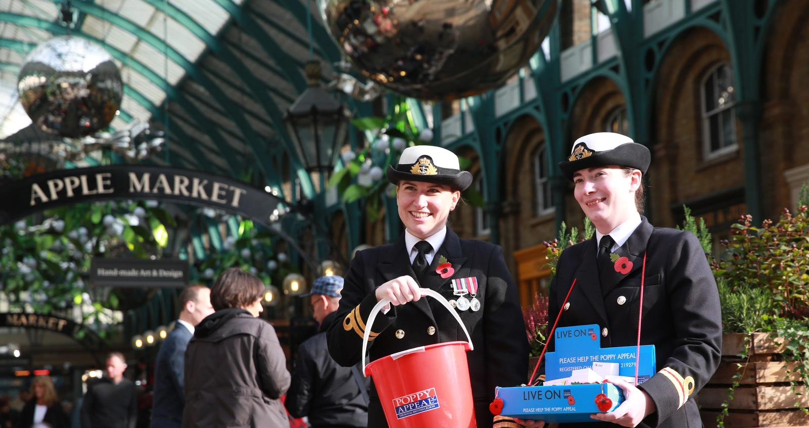 Poppy Appeal collectors in a market Royal British Legion Poppy Appeal collectors in a market