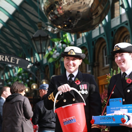 Royal British Legion Poppy Appeal collectors in a market