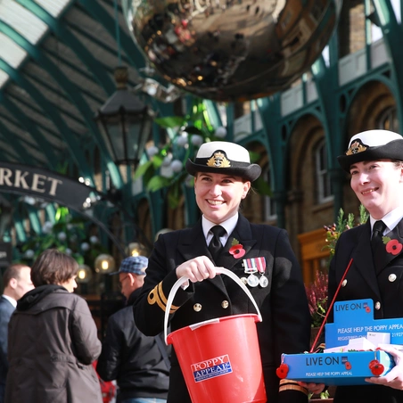 Poppy Appeal collectors in a market Royal British Legion Poppy Appeal collectors in a market