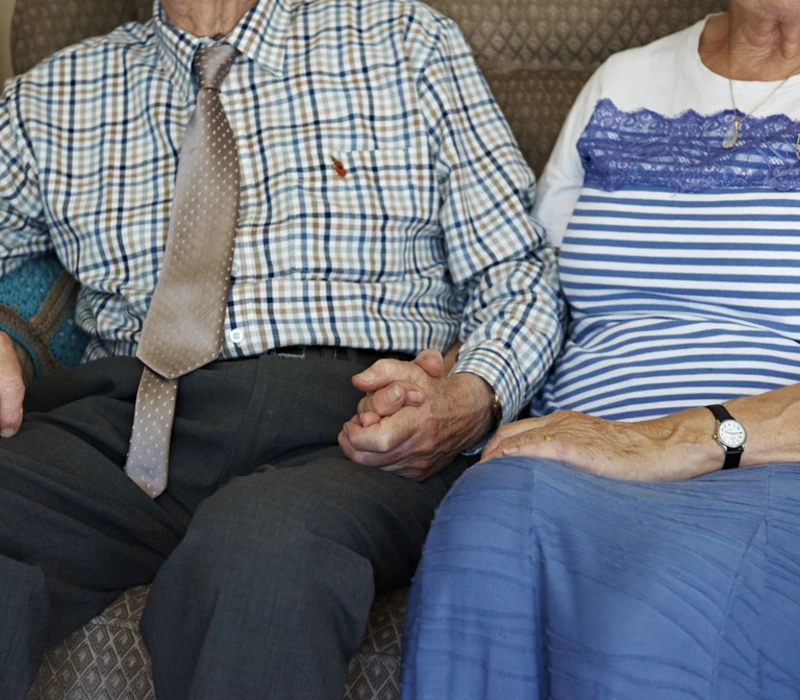 A veteran couple holding hands