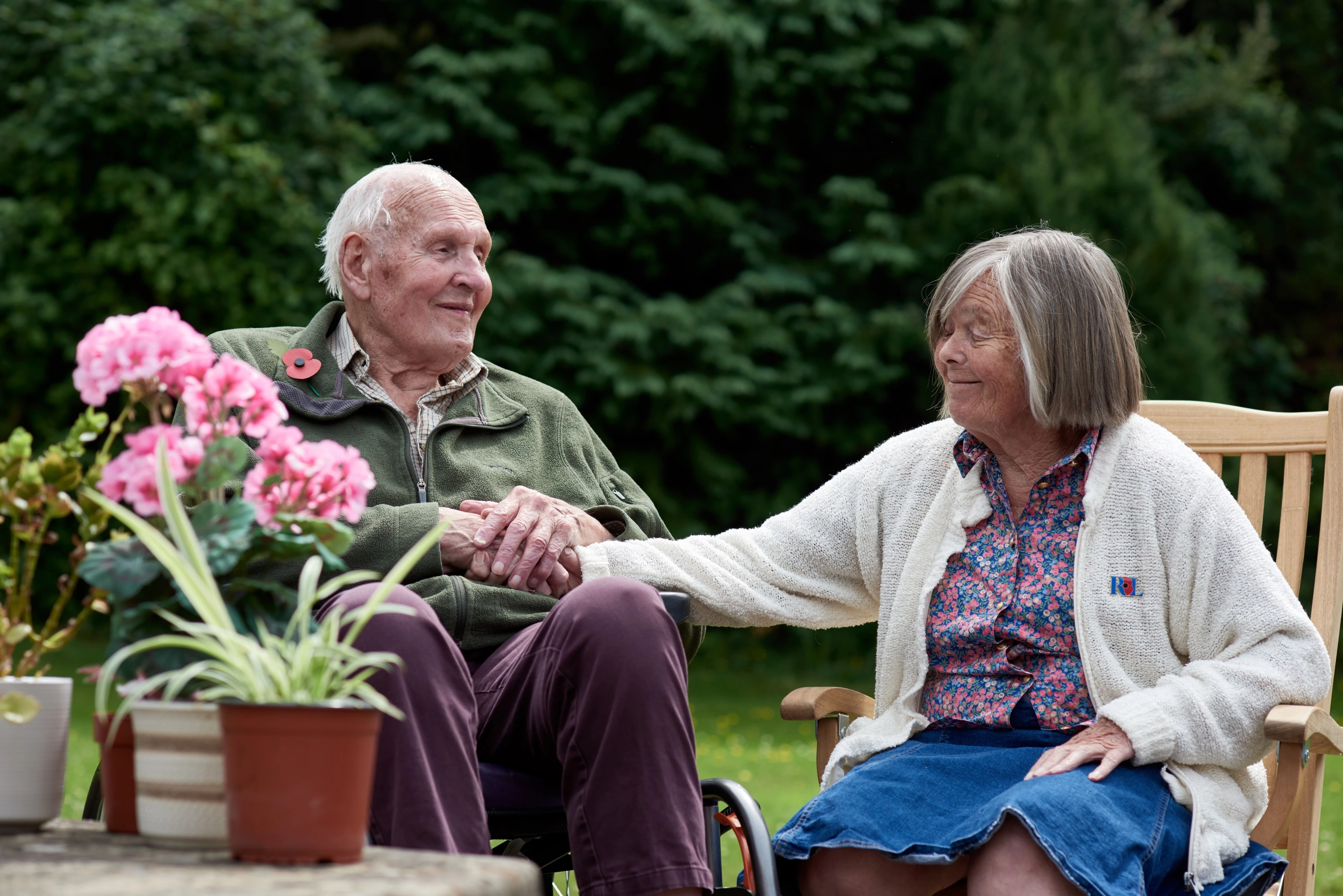 Man and woman holding hands in garden