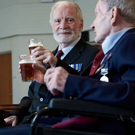Two uniformed veterans having a drink