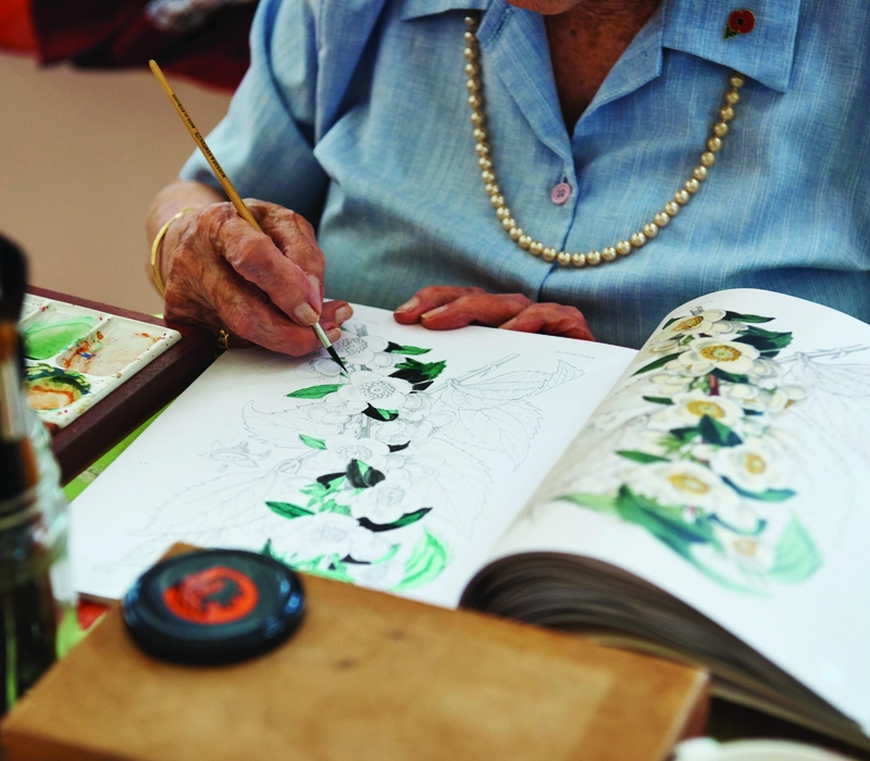 A resident painting at a Royal British Legion care home