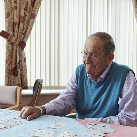 A resident playing cards at a Royal British Legion care home