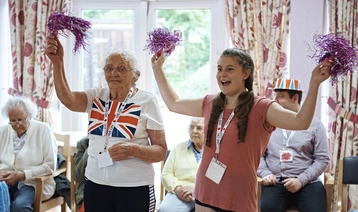 A volunteer with a veteran at a Royal British Legion care home