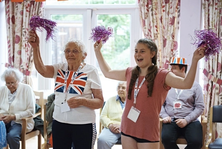 Ladies chatting in care home A volunteer with a veteran at a Royal British Legion care home