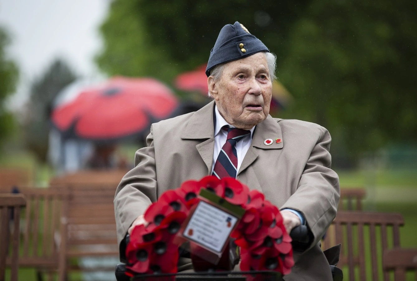 Normandy veteran carrying wreath