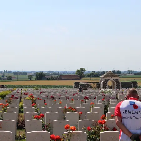 Cyclist from Pedal to Ypres ride at a graveyard in Ypres