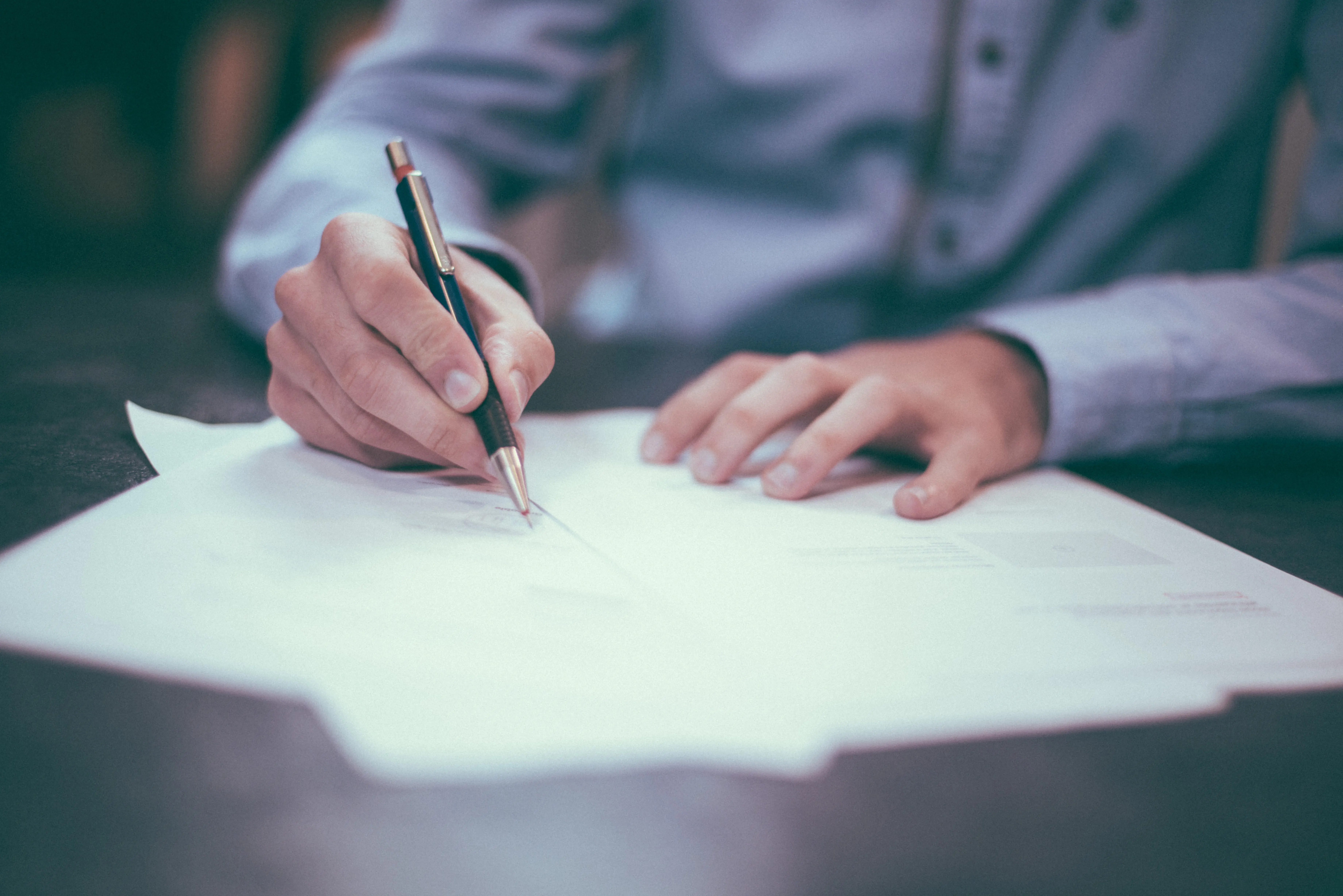 Man writing out procurement documents at the Royal British Legion