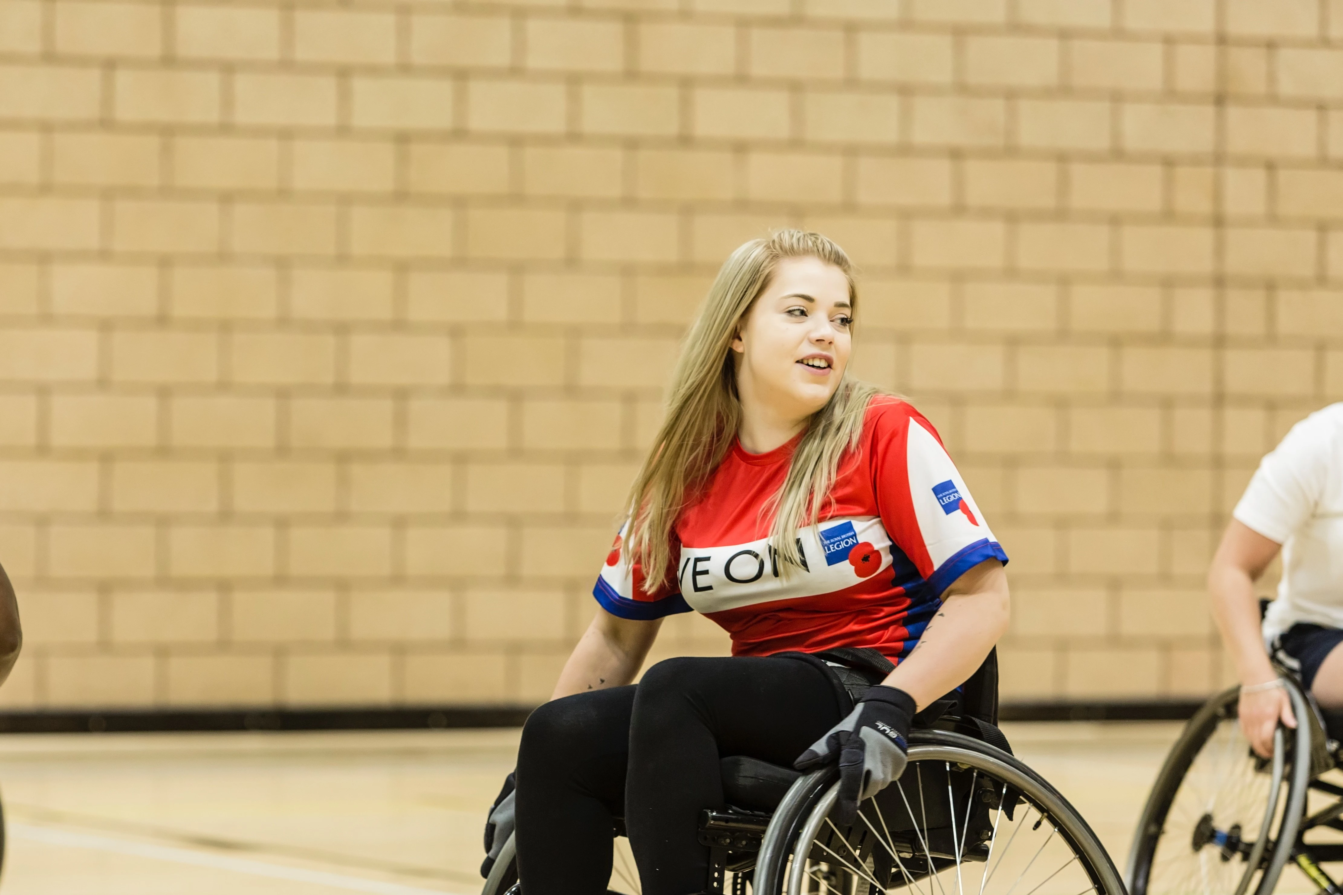 Woman from a recovery centre playing wheelchair basketball