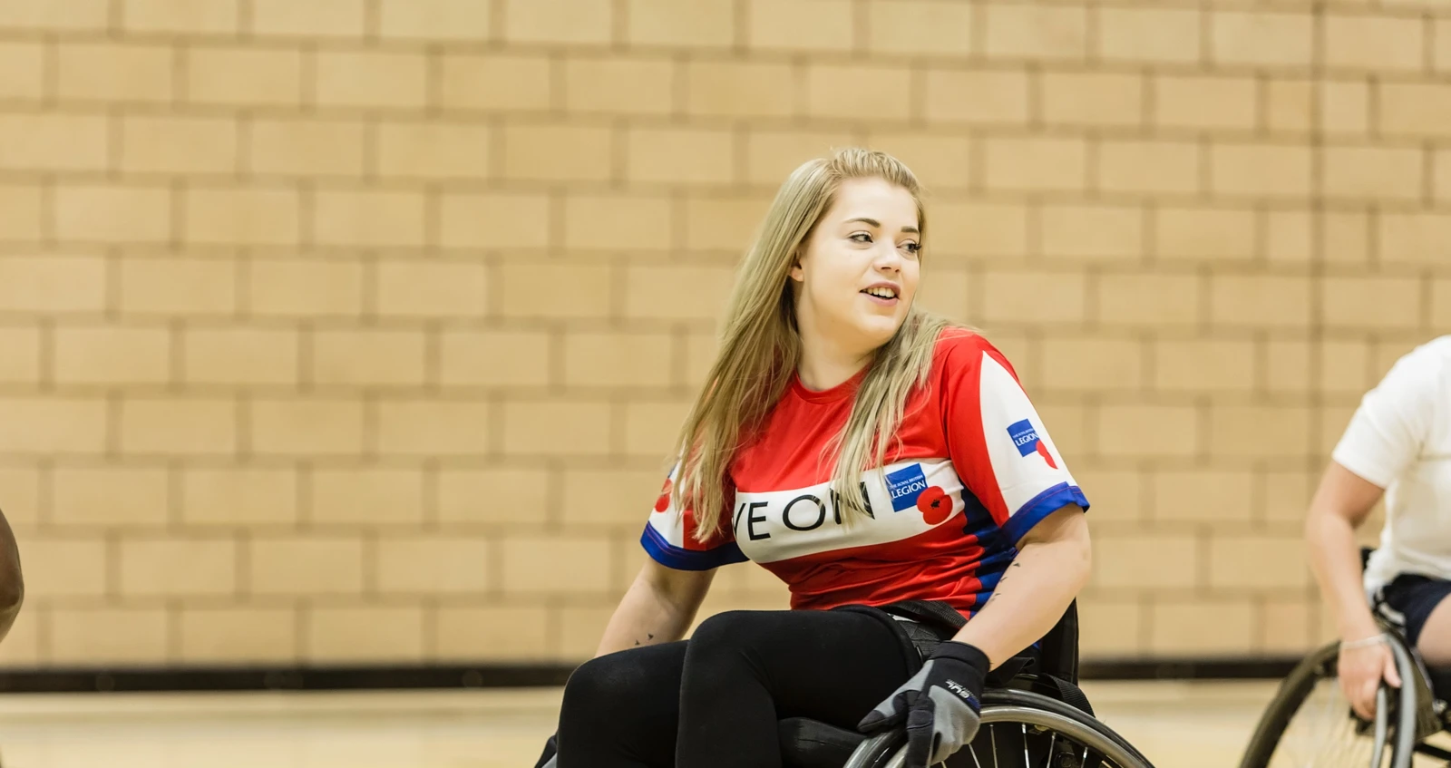 Woman from a recovery centre playing wheelchair basketball