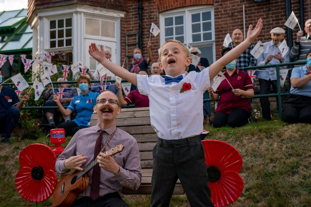 Lee and Noah outside singing outside care home