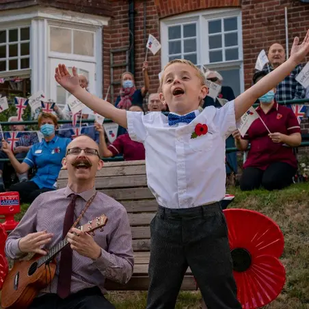 Lee and Noah outside Mais House Lee and Noah outside singing outside care home