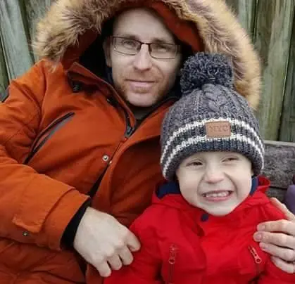 Father and son smiling