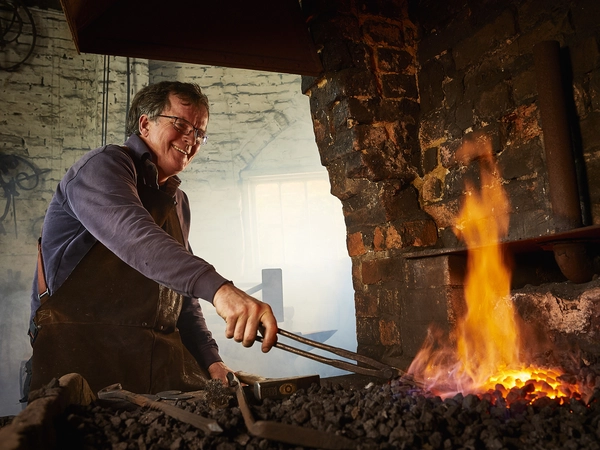 Veteran Tim Mackereth working as a blacksmith