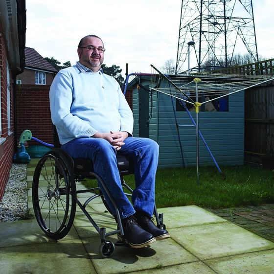 Man sitting in garden in a wheelchair