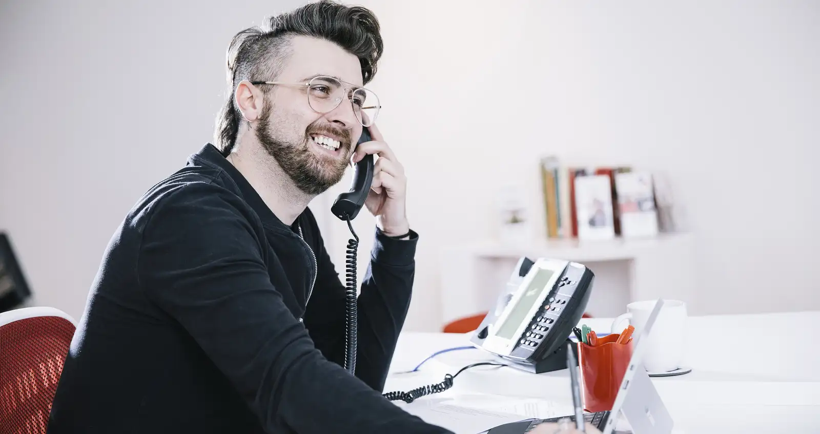 LGBTQ+ Telephone Card Image Man on telephone at desk