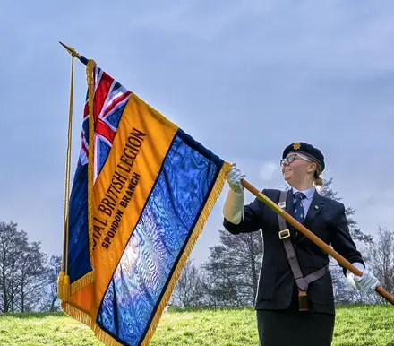 Youth member Maddie Hempell holding her branch Standard Youth member Maddie Hempell holding her branch Standard