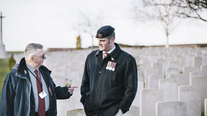 Veteran Liam Young  standing at a graveyard on a trip to the battlefields of the First World War