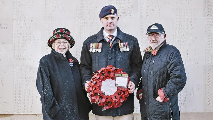 Veteran Liam Young holding a poppy wreath on a trip to the battlefields of the First World War
