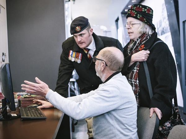 Veteran Liam Young speaking to a researcher on his computer on a trip to the battlefields of the First World War
