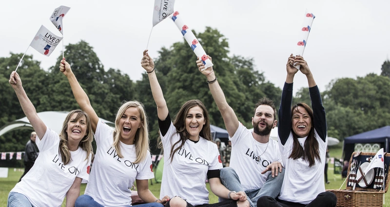 Members of the Royal British Legion cheering at a social event