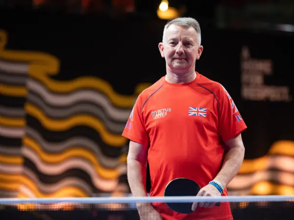 Al Dyer Al Dyer stood holding a bat at a table tennis table at the Invictus Games in Germany