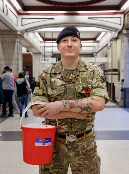 Ashley Martin with collecting bucket in Tube station - Portrait Ashley Martin with collecting bucket in Tube station - Portrait