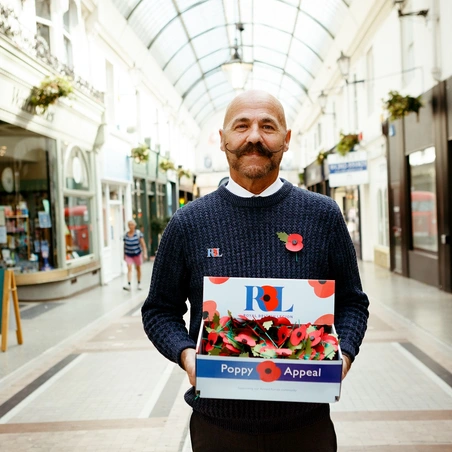 Dave Kelsey holding poppy tray Dave Kelsey holding poppy tray
