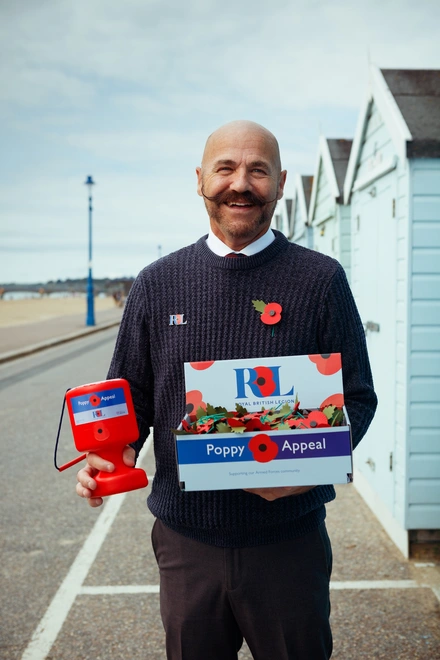 Dave Kelsey with poppies on Brighton seafront
