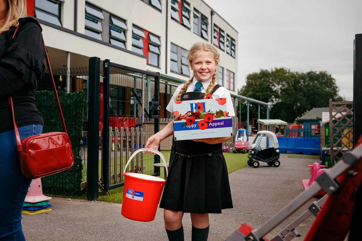 Maisie Mead with collection bucket outside her school