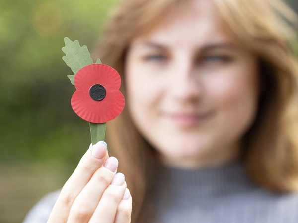 A new plastic-free poppy being held in one hand