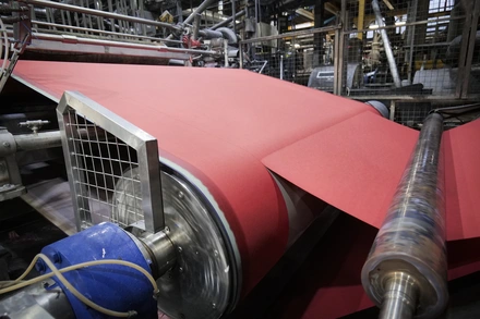 Roll of red paper being manufactured by James Cropper