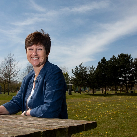 Woman sitting at park bench