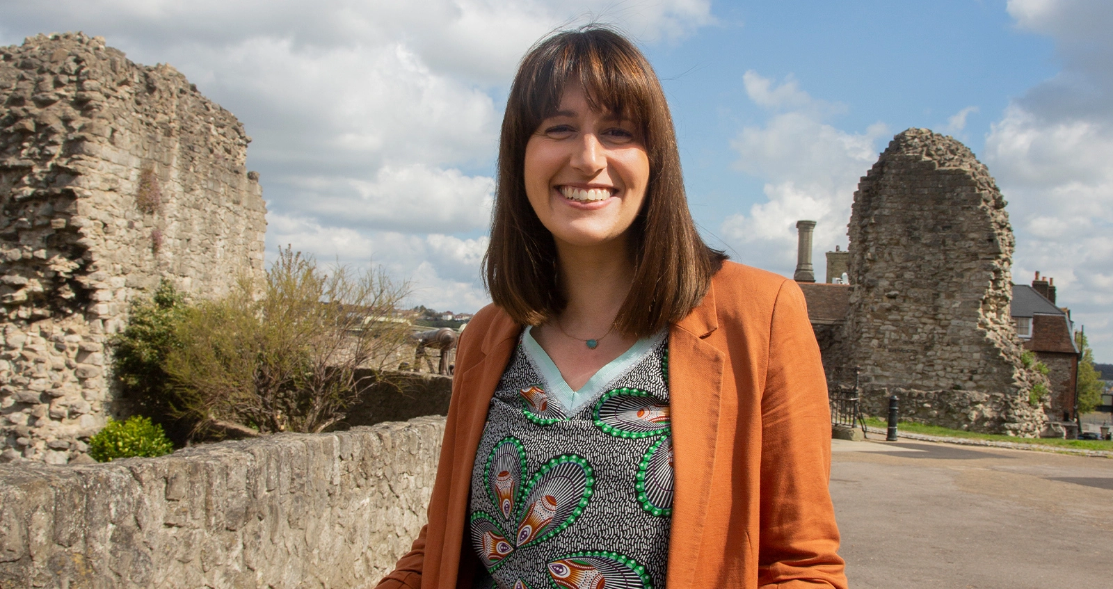 Woman standing next to castle