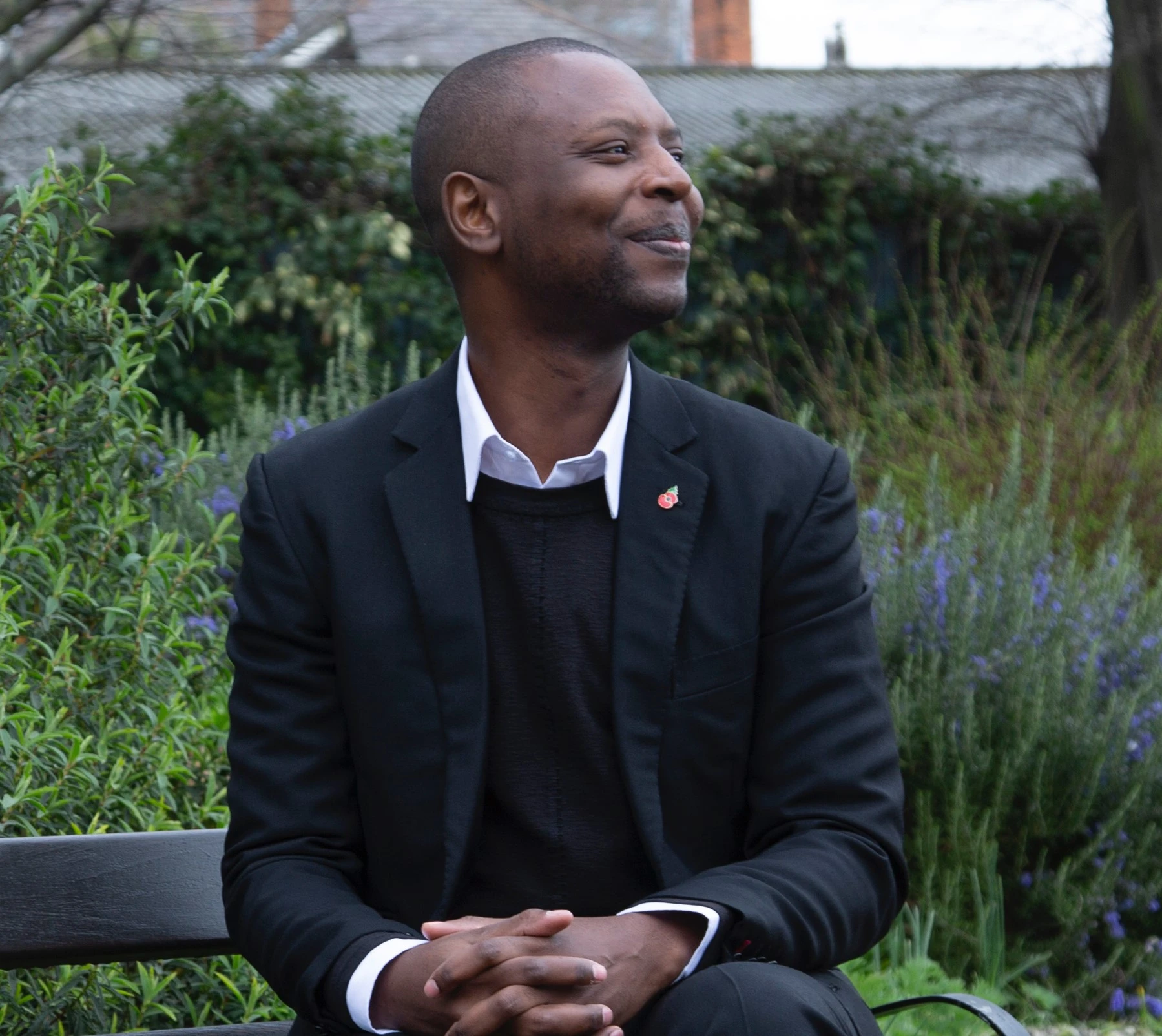 Henry Okello sitting on the bench