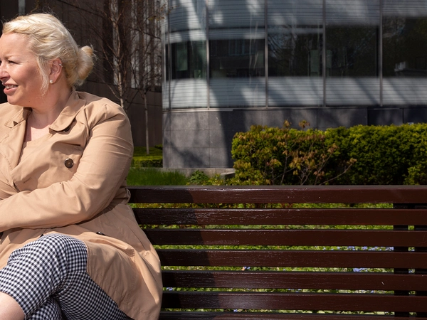 Angela 1 Woman sitting on bench outside
