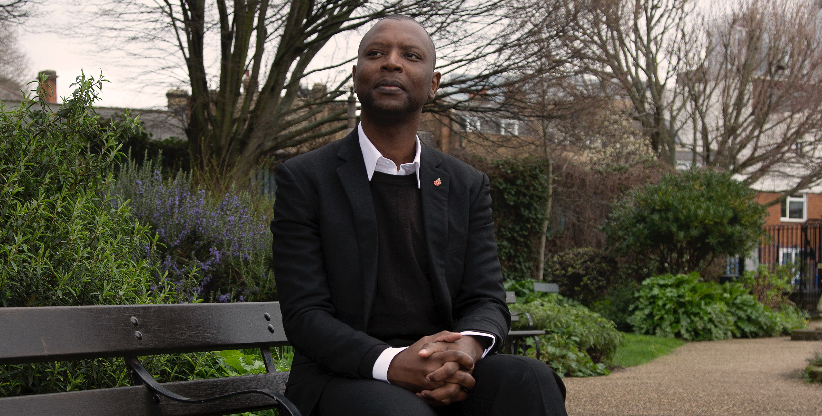 Man sitting on bench in park