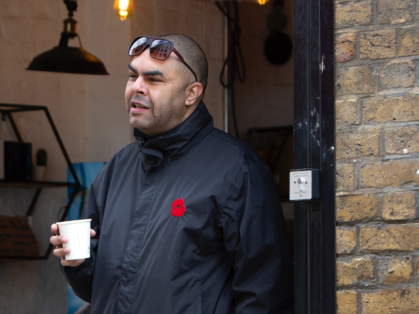 What we offer_Leroy Man leaning on door with cup of tea