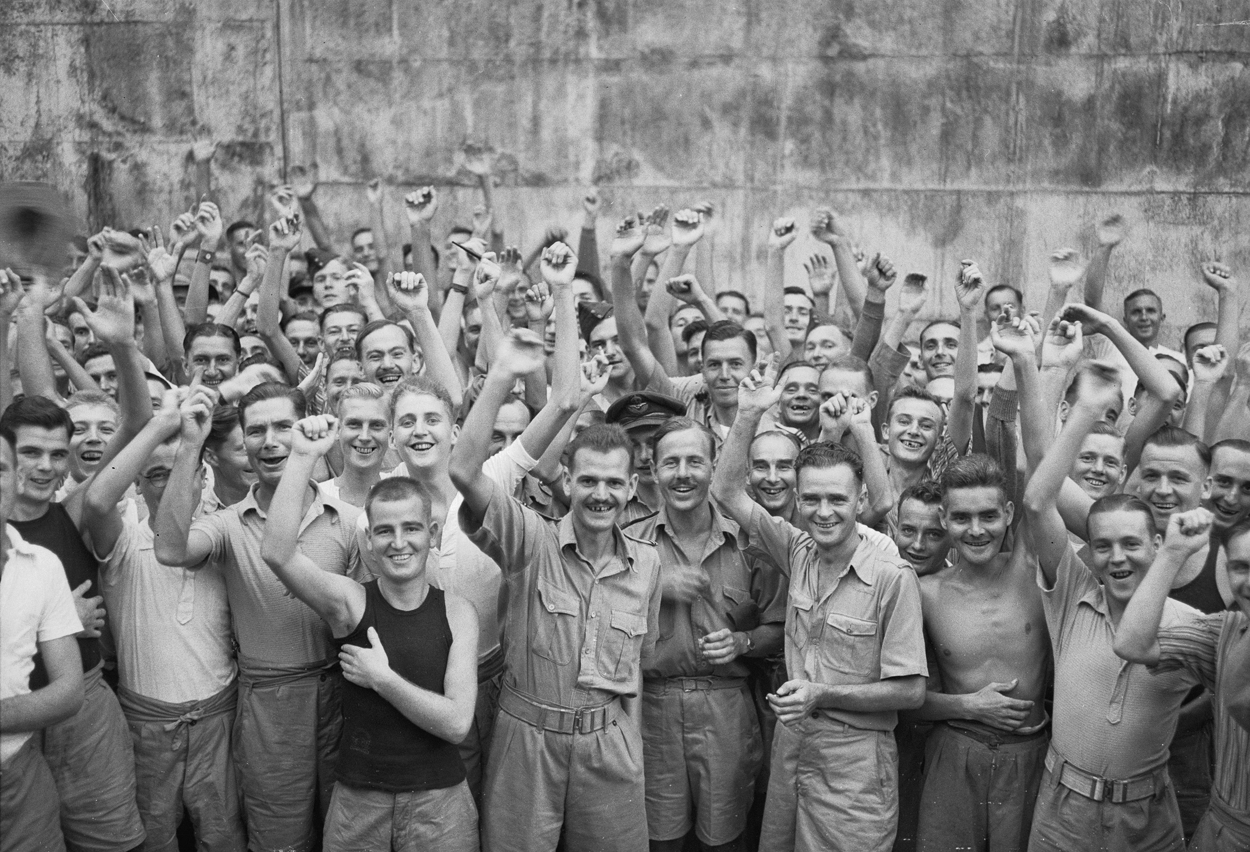 Allied prisoners of war celebrating their liberation from Changi Jail, Singapore © IWM (CF 712)