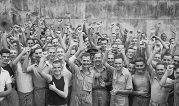 Allied prisoners of war celebrating their liberation from Changi Jail, Singapore © IWM (CF 712)