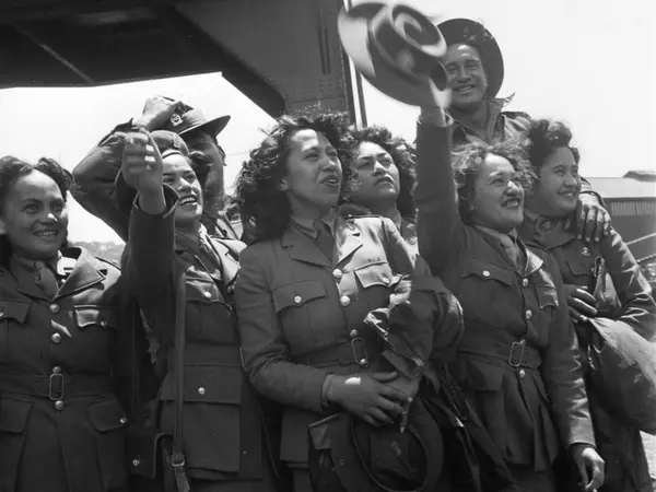Uniformed Maori members of the Women's Auxiliary Army Corps welcome the Maori Battalion home on Wellington wharf