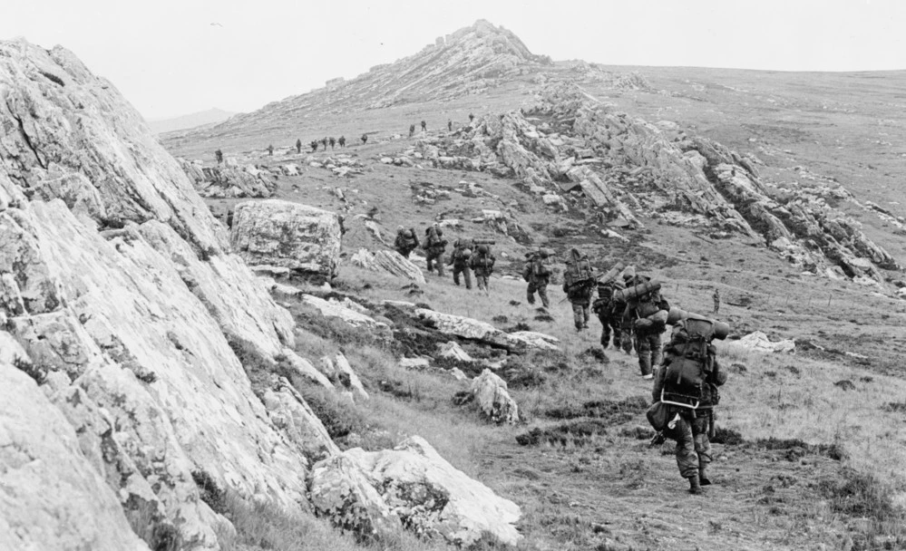 42 Commando, Royal Marines, moves off Mount Harriet during the mountain battles