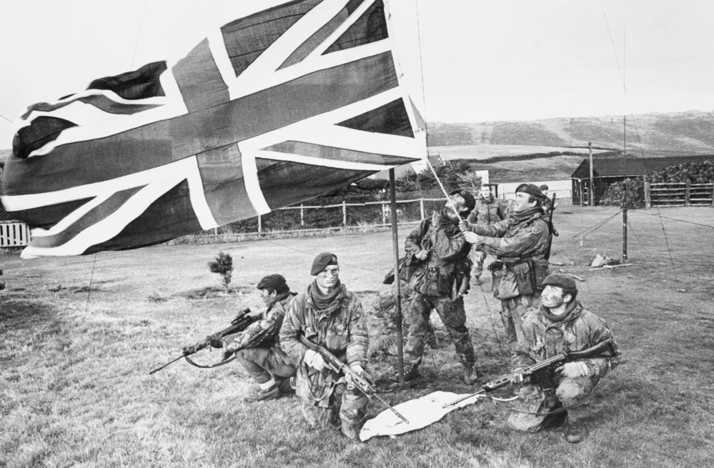 Marines of 40 Royal Marine Commando raise the British flag on West Falkland after the Argentine surrender