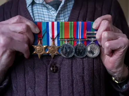 Peter Lovett holding medals Peter Lovett holding medals