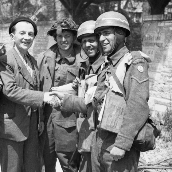 French civilian greets British troops after D-Day